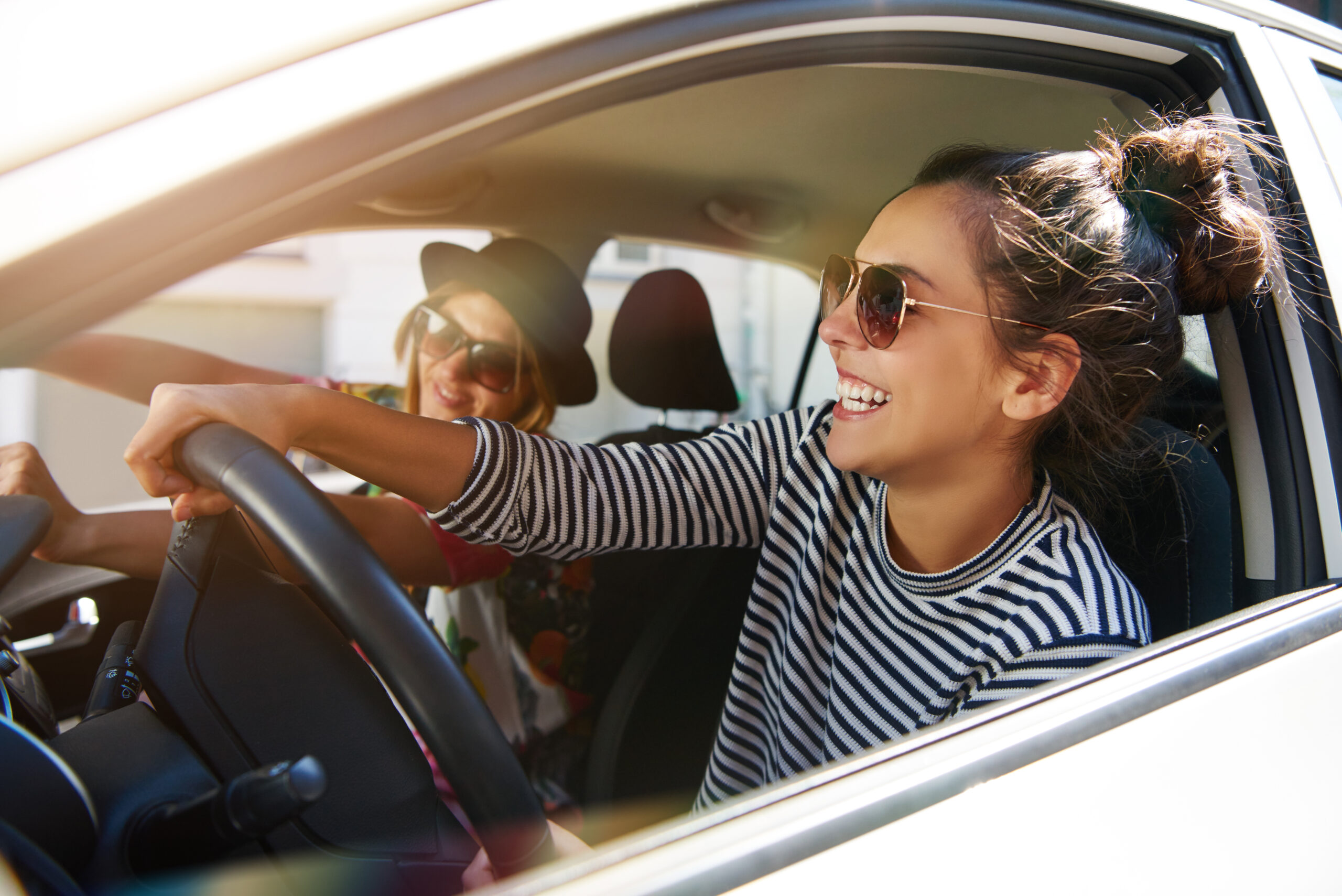 Two,Fun,Young,Women,In,Sunglasses,Driving,In,A,Car